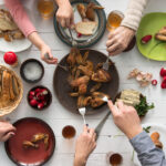 family having roasted chicken wings for dinner